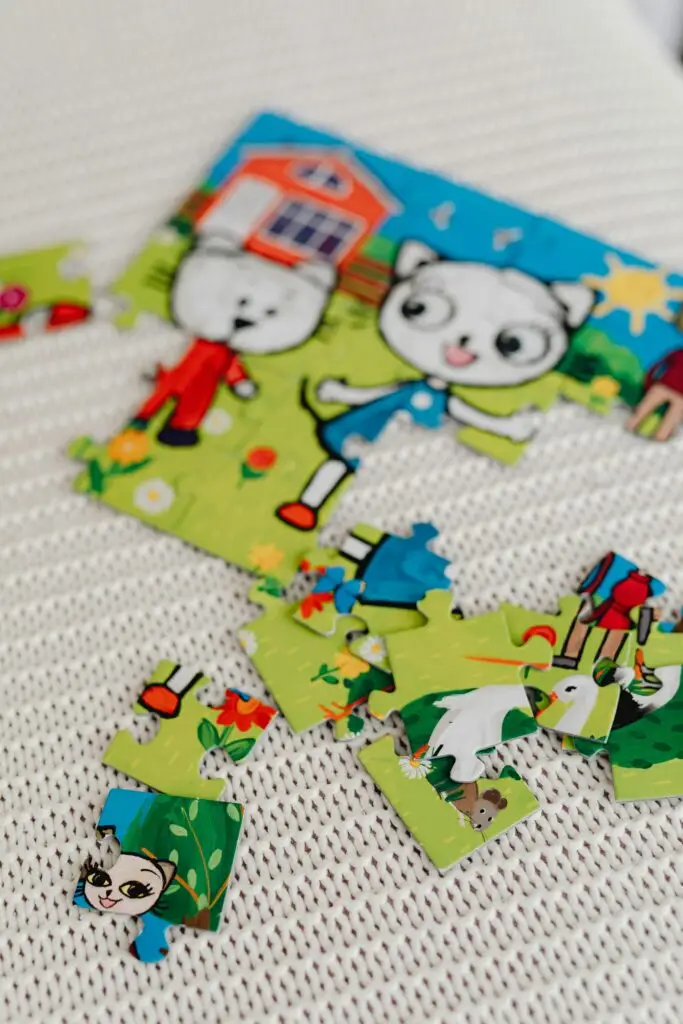 Close-up of a colorful children's puzzle depicting cartoon animals on a textured surface.